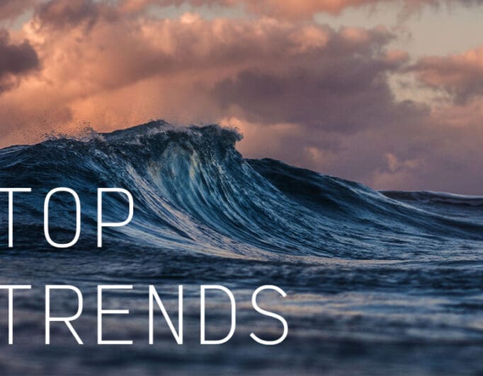 An ocean wave during a cloudy sunset with the caption "Top Trends".