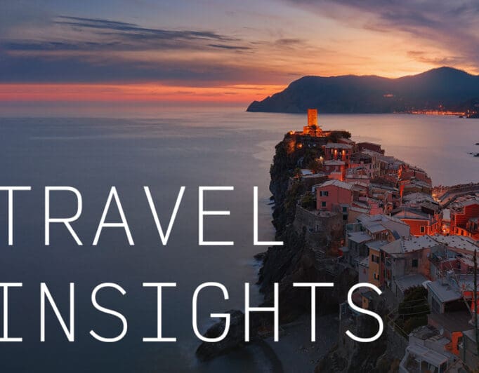 A coastal city on a cliff overlooking the ocean with the caption "Travel Insights".