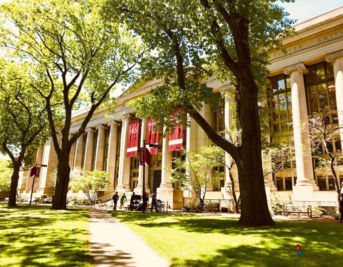 A university building with trees in front of it.